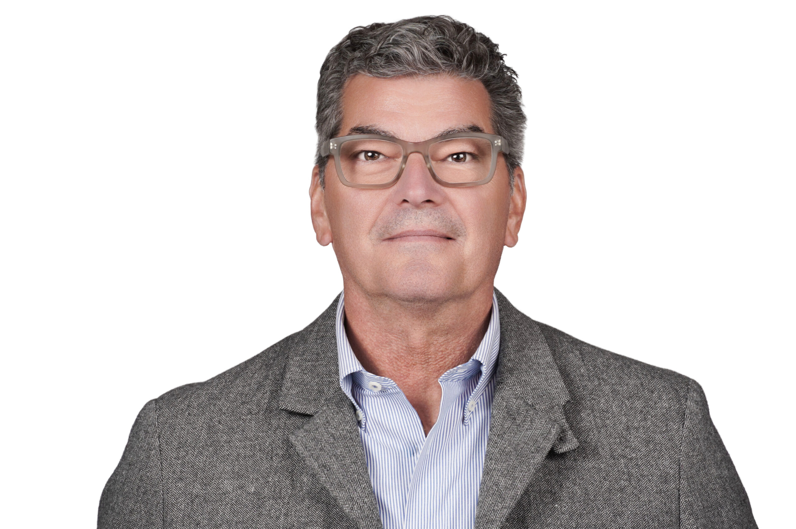 Professional headshot of a man wearing glasses and a gray blazer against a clean light background